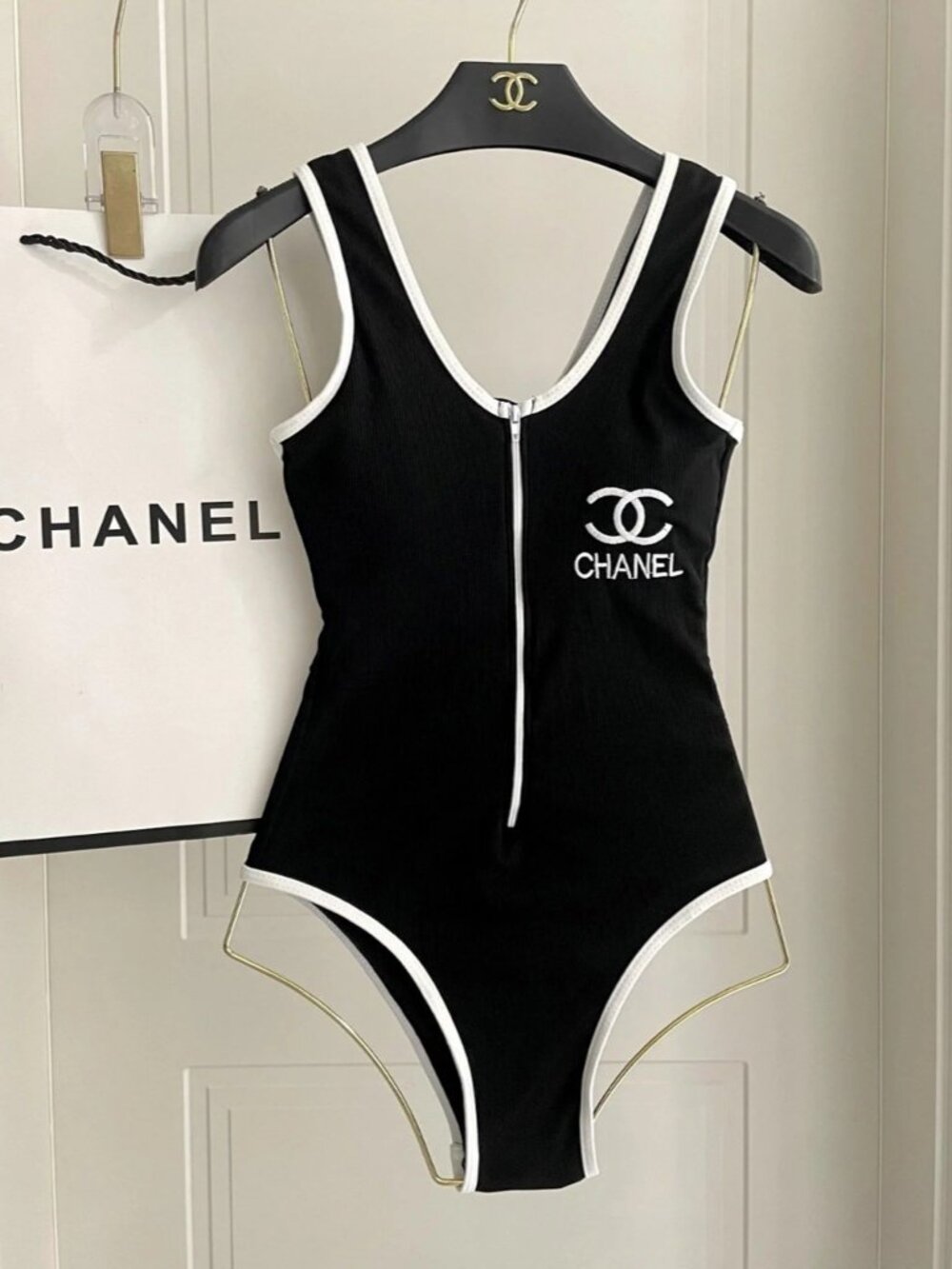 Chanel's black one-piece swimsuit features the iconic double C logo.